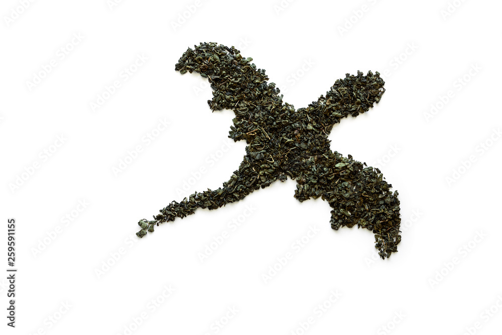 Dragon made from dry green tea on white background. Minimal, creative or food art concept. Copy space. Top view Dragon made from dry green tea on white background. Minimal, creative or food art concept. Copy space. Top view