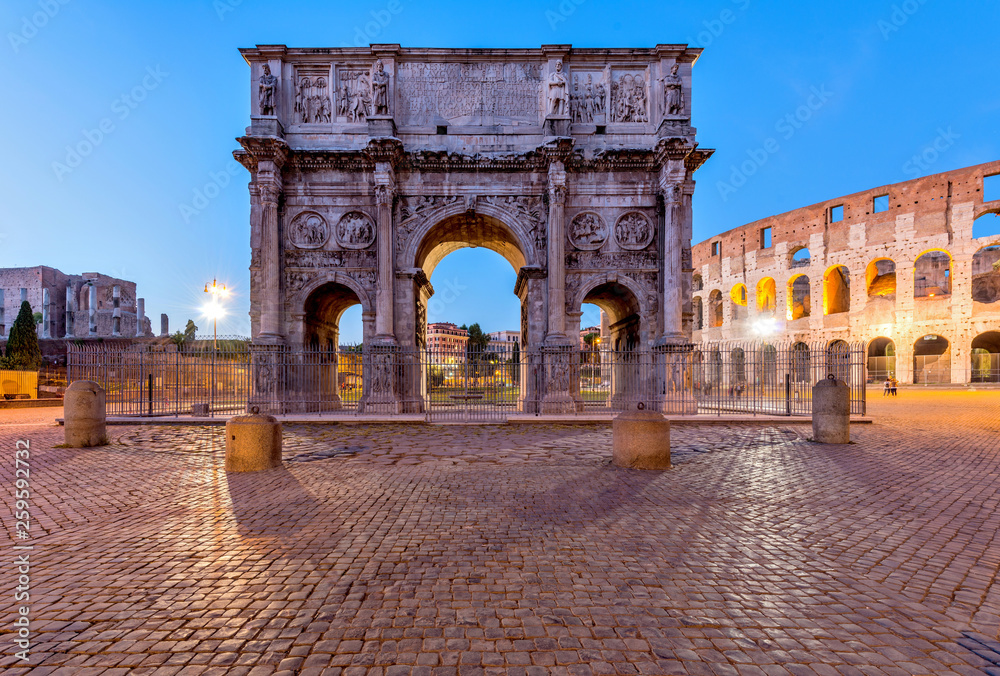 Arch of Constantine - A dusk view of south side of Constantine's Arch, standing at between the Colosseum, right, and the Roman Forum, left. Rome, Italy.