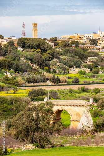 Springtime view of Mtarfa from Mdina, Malta with an old bridge in the foreground photo