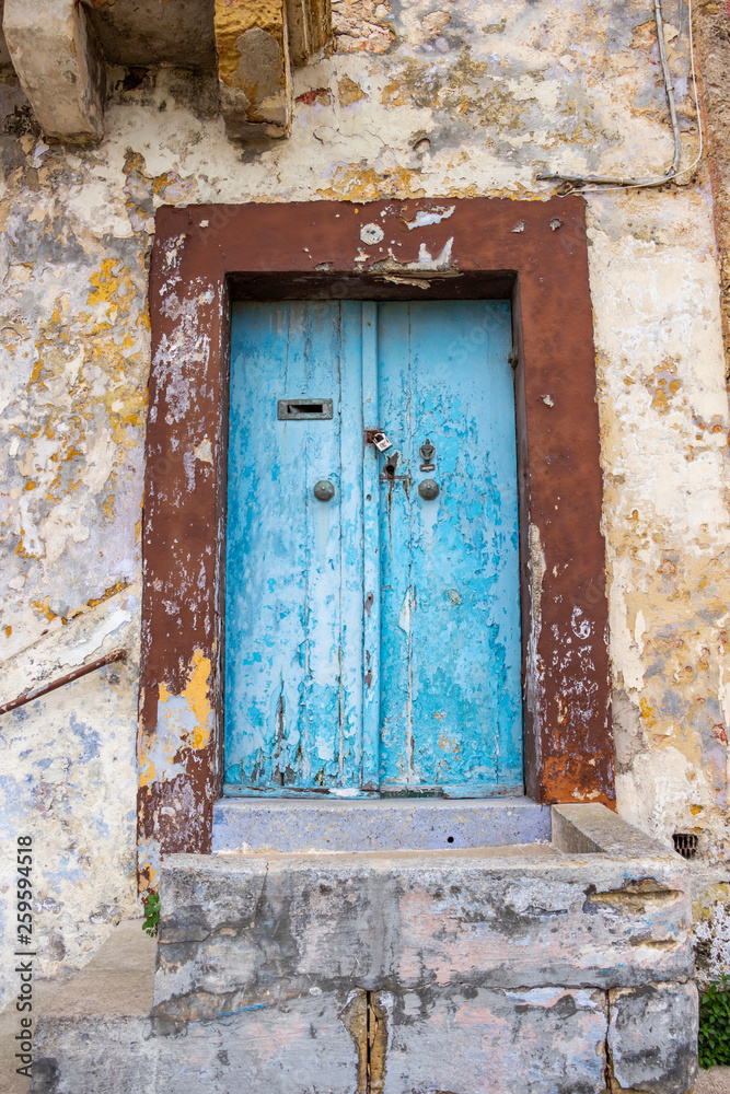 Beautiful old, light blue painted, weathered, locked door of an abandoned building at Rabat, Malta Beautiful old, light blue painted, weathered, locked door of an abandoned building at Rabat, Malta