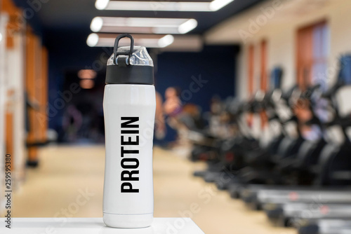 Back view sportsman holds pack of protein pills photo