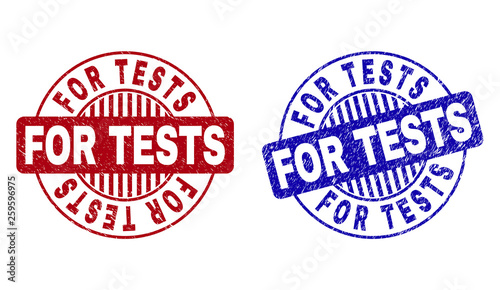 Grunge FOR TESTS round stamp seals isolated on a white background. Round seals with grunge texture in red and blue colors. Vector rubber imitation of FOR TESTS text inside circle form with stripes.