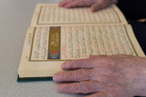 the old woman reading Quran. Holy book Koran for Muslims holiday, Ramadan,blessed Friday message .