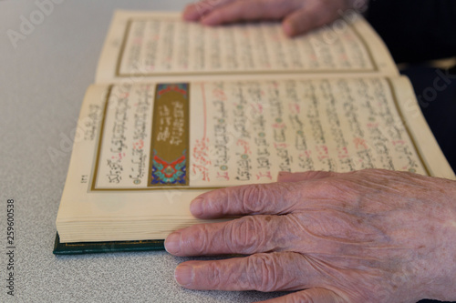 the old woman reading Quran. Holy book Koran for Muslims holiday, Ramadan,blessed Friday message .