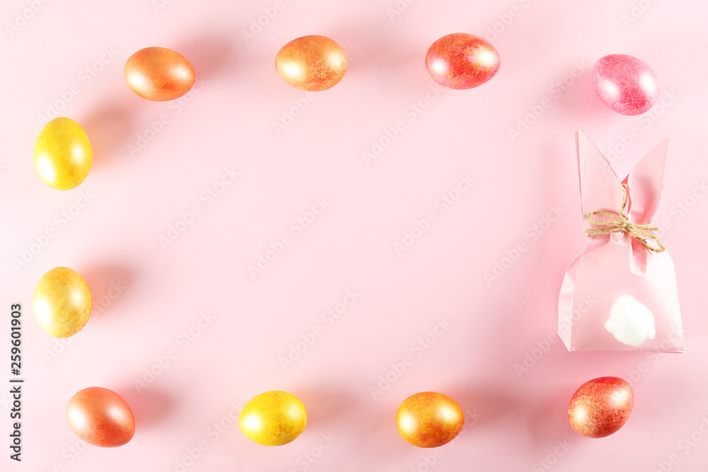 Golden and rose gold Easter eggs in beautiful flat lay pastel colored composition on pale pink paper background. Top view, copy space. Golden and rose gold Easter eggs in beautiful flat lay pastel colored composition on pale pink paper background. Top view, copy space.