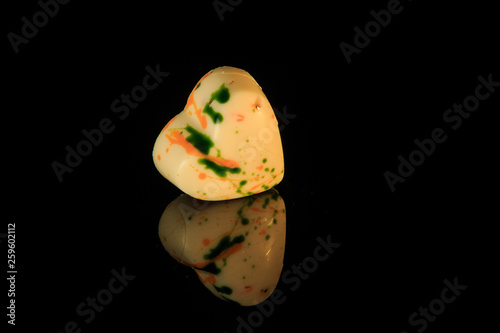 single heart-shaped white chocolate candy with colorful decoration