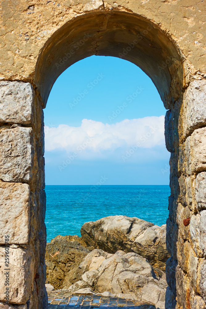 Mediterranean sea through the arch in Cefalu