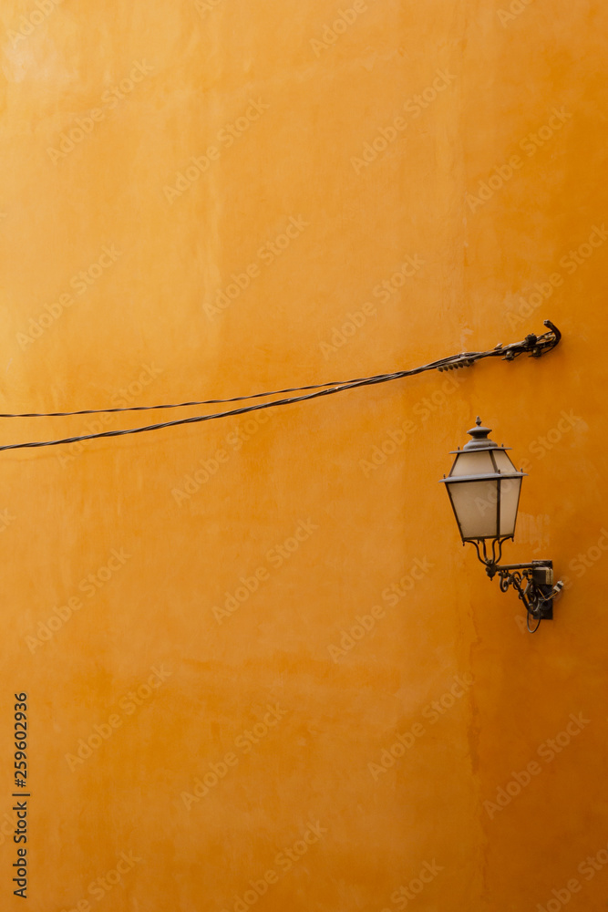 Orange wall with street lamp