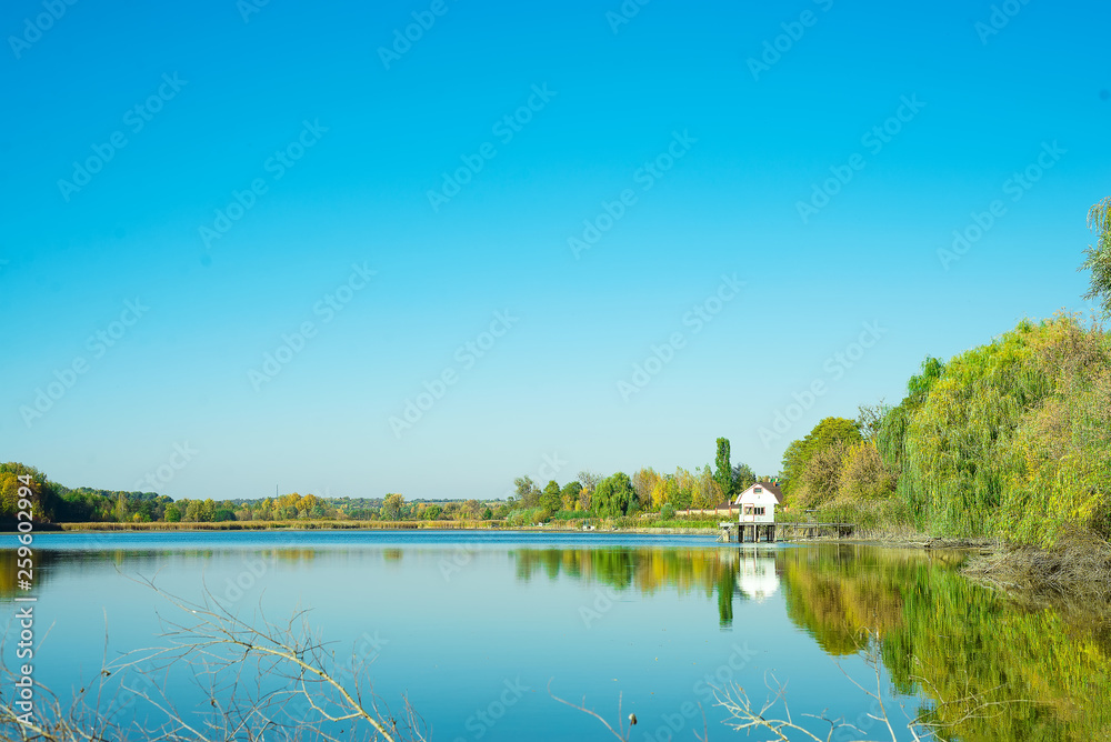 Amazing landscape of lake with clear green water and Perfect blue sky. Ukraine