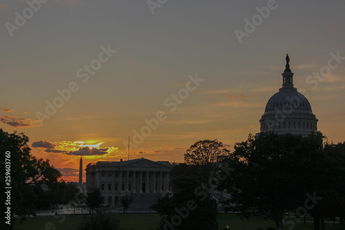 silhouette of capitol hill and washington monument in downtown washington DC during twilight in a sunset with some clouds