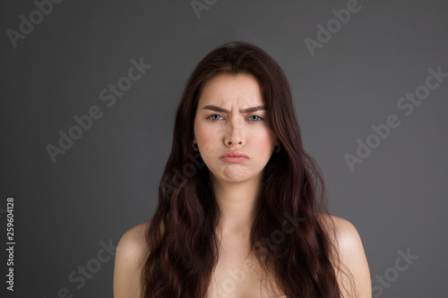 Portrait of saddend girl showing hurt and sadness, looking sad