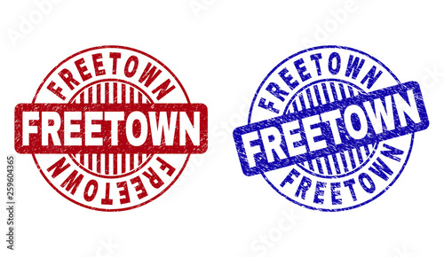 Grunge FREETOWN round stamp seals isolated on a white background. Round seals with grunge texture in red and blue colors. Vector rubber imprint of FREETOWN text inside circle form with stripes.