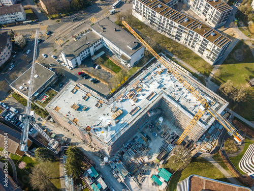 Aerial view of construction site in Switzerland with large yellow crane