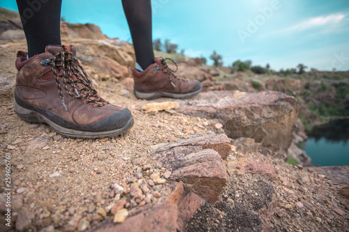 woman hiker at mountain peak standing enjoying trail path