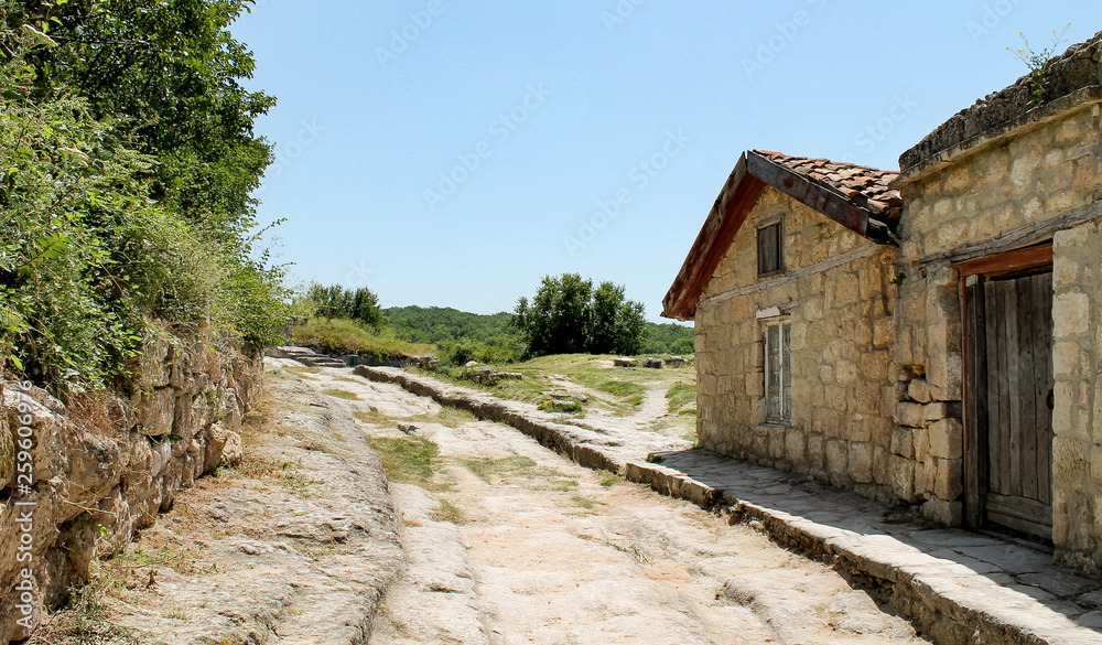 old house and stone road in summer