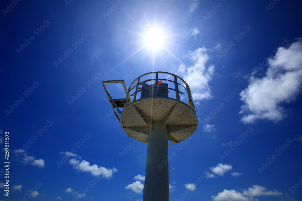 emergency Alarm tower and sun over blue sky in sunny day, storm or Tsunami siren warning loudspeakers are installed on the beach in Thailand emergency Alarm tower and sun over blue sky in sunny day, storm or Tsunami siren warning loudspeakers are installed on the beach in Thailand