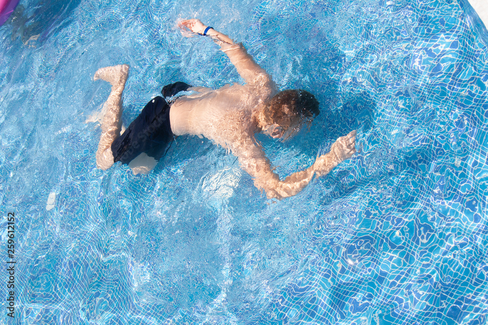 Underwater Young Boy in the Swimming Pool. Summer Vacation Fun.