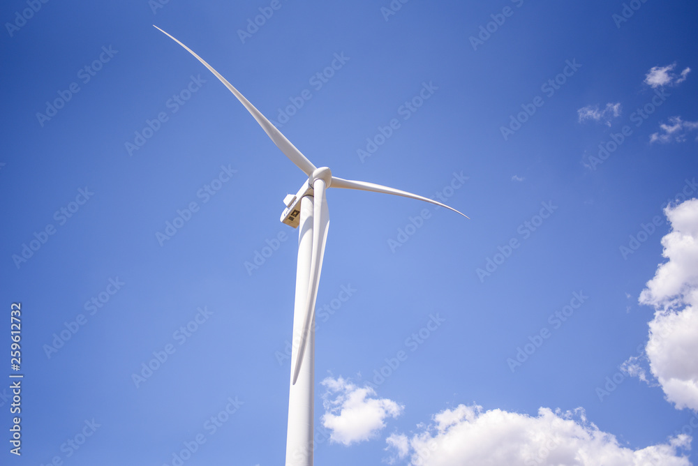white windmill against blue sky background white windmill against blue sky background