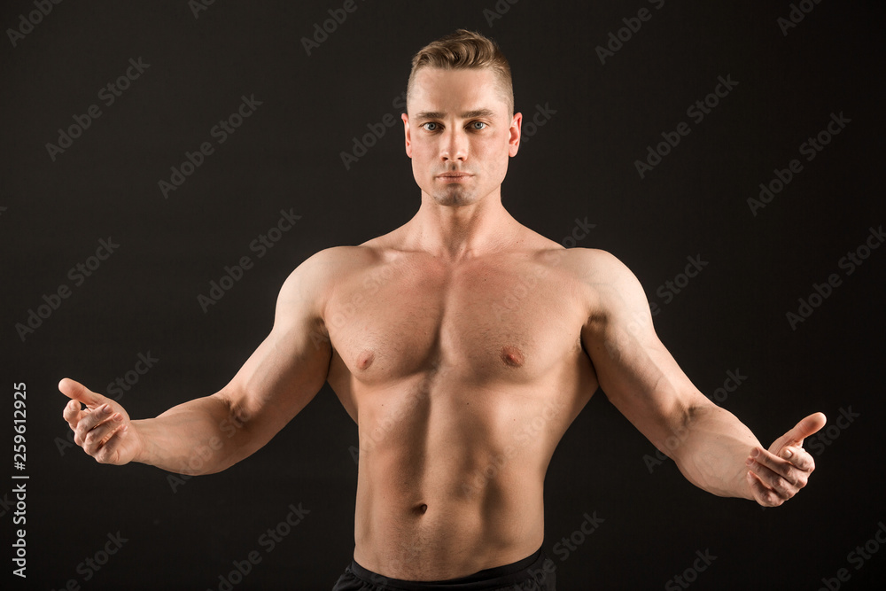 Fototapeta premium handsome muscular man on black background