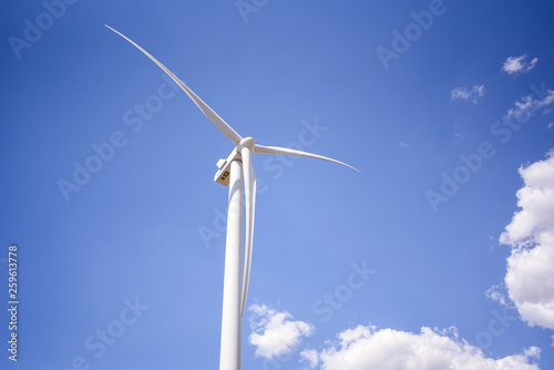 white windmill against blue sky background