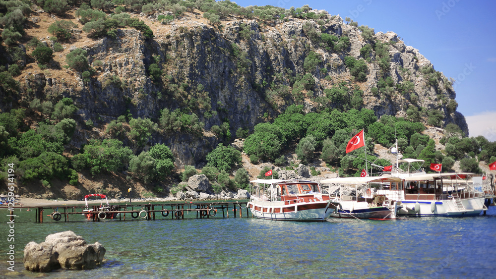  Beautiful beach view and blue Amos bay  in  Marmaris  Turkey. Boat for tourists, sea transport