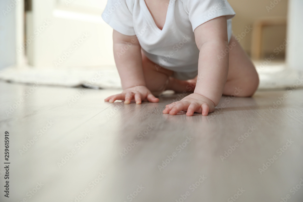 Cute little baby crawling on floor indoors, closeup with space for text Cute little baby crawling on floor indoors, closeup with space for text
