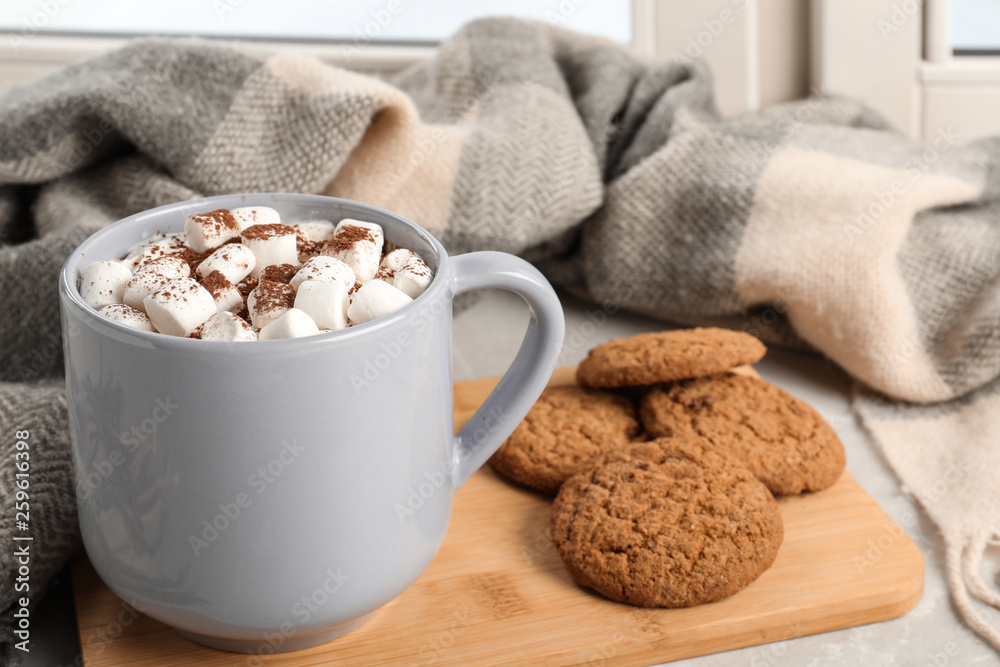 Composition with cup of cocoa and cookies on windowsill. Winter drink