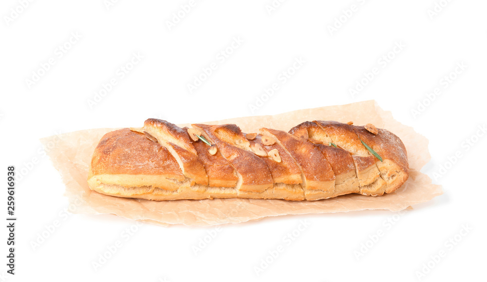 Parchment paper with tasty garlic bread isolated on white Parchment paper with tasty garlic bread isolated on white
