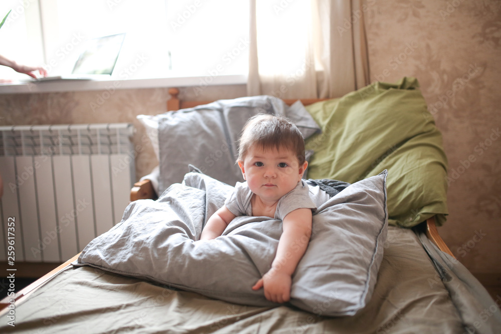funny shaggy baby on bed with pillow, waking up funny shaggy baby on bed with pillow, waking up
