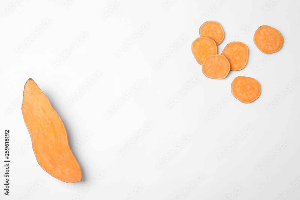 Composition with slices of sweet potatoes and space for text on white background, top view Composition with slices of sweet potatoes and space for text on white background, top view