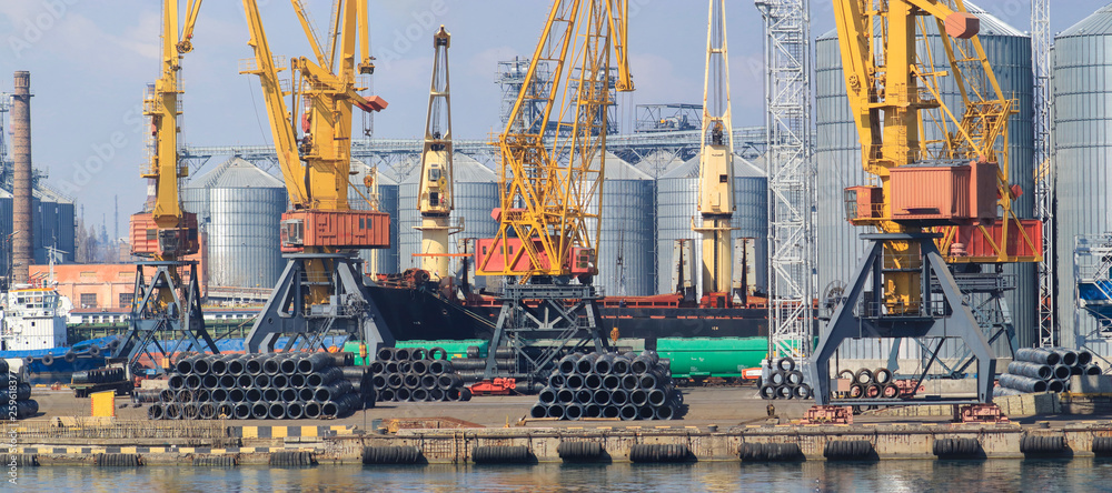 Lifting cargo cranes, ships and grain dryer in Sea Port of Odessa, Black Sea, Ukraine