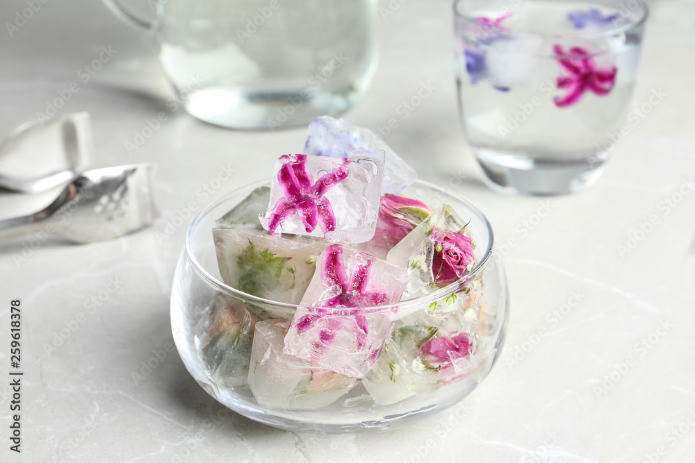 Glass bowl of floral ice cubes on table Glass bowl of floral ice cubes on table