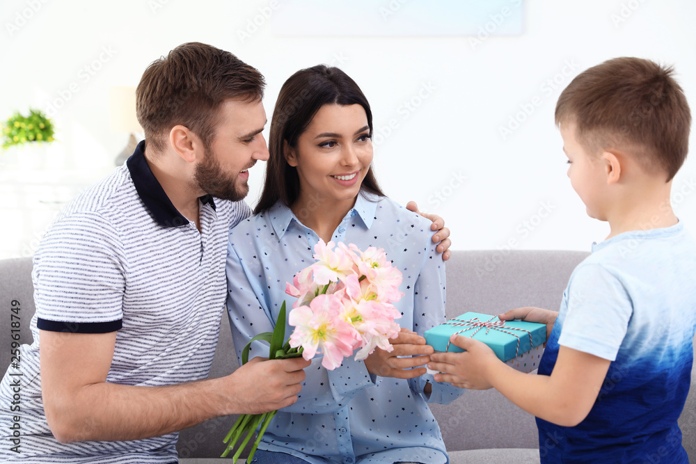 Father and son congratulating mom at home. Happy Mother's Day Father and son congratulating mom at home. Happy Mother's Day