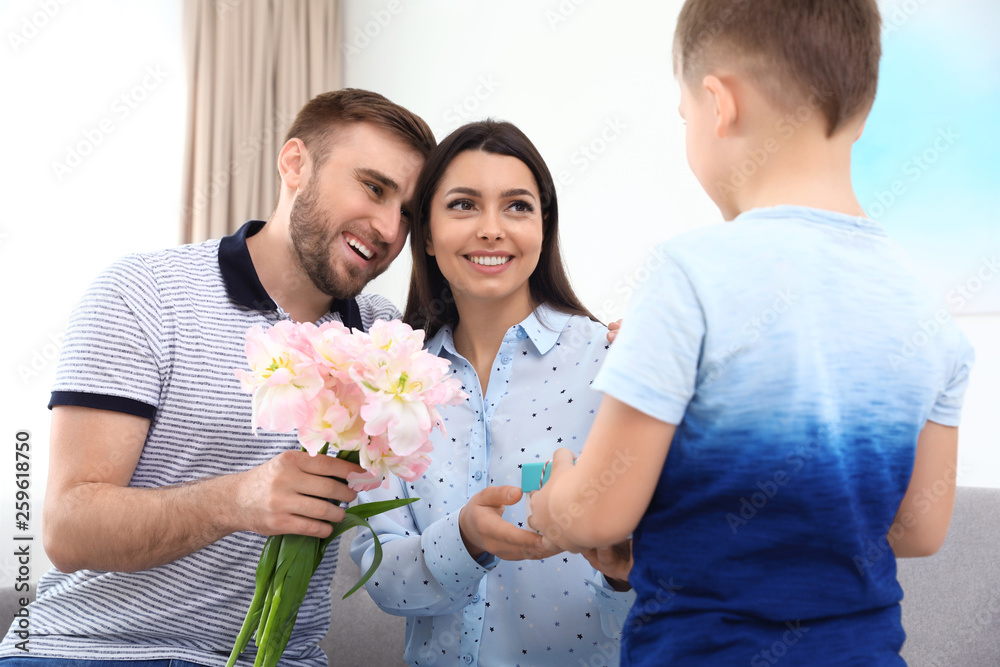 Father and son congratulating mom at home. Happy Mother's Day Father and son congratulating mom at home. Happy Mother's Day