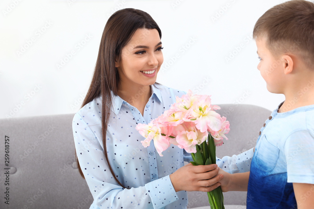 Little son congratulating his mom at home. Happy Mother's Day