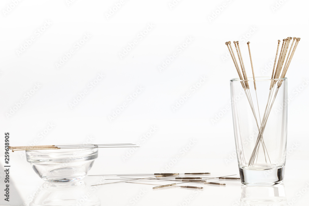 Silver needles for traditional Chinese acupuncture medicine. White background. Silver needles for traditional Chinese acupuncture medicine. White background.