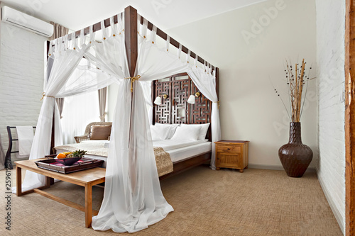 Luxurious modern bedroom interior with canopy bed photo