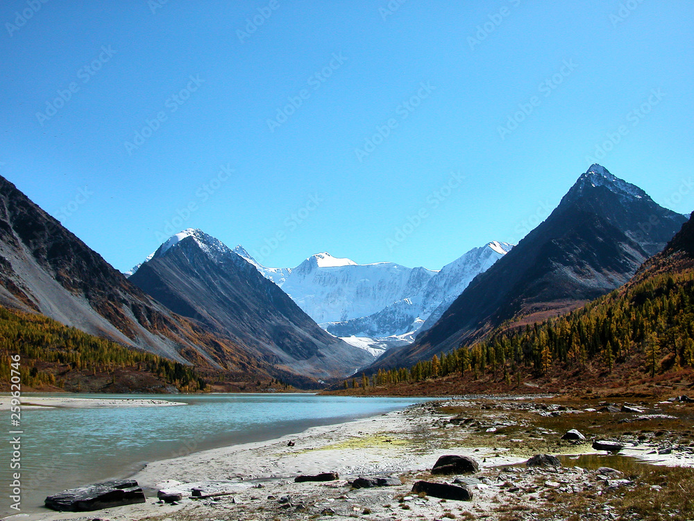 Landscape of Roerich. Belukha Mountain and Lake Akkem near the border between Russia and Kazahstan, snow peaks and glacier during golden autumn, Altai, Siberia, Russia