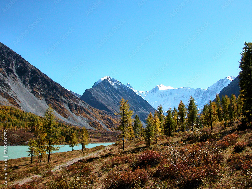 Landscape of Roerich. Belukha Mountain and Lake Akkem near the border between Russia and Kazahstan, snow peaks and glacier during golden autumn, Altai, Siberia, Russia Landscape of Roerich. Belukha Mountain and Lake Akkem near the border between Russia and Kazahstan, snow peaks and glacier during golden autumn, Altai, Siberia, Russia