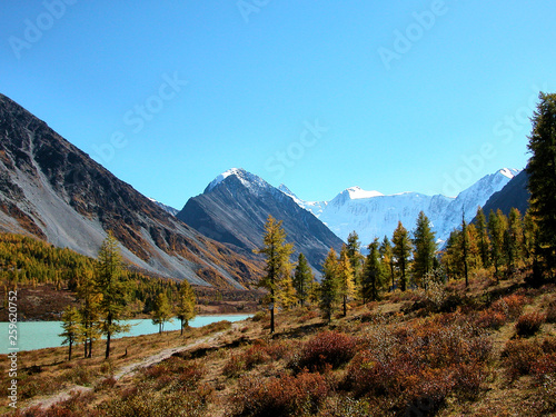 Landscape of Roerich. Belukha Mountain and Lake Akkem near the border between Russia and Kazahstan, snow peaks and glacier during golden autumn, Altai, Siberia, Russia