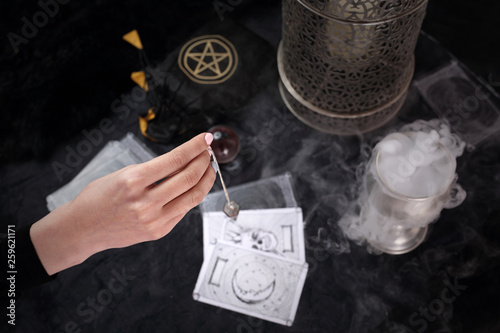 Fotografija Fortune-telling, the fortune-teller puts tarot cards and spells the pendulum