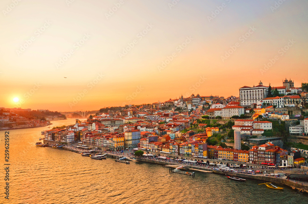 Magnificent sunset over the Porto city center and the Douro river, Portugal. Dom Luis I Bridge is a popular tourist spot as it offers such a beautiful view over the area.