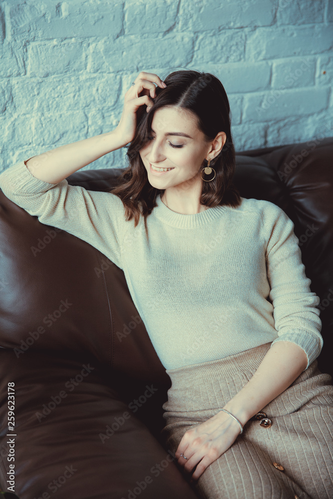 Beautiful woman posing for the camera sitting in a cafe. Beautiful woman posing for the camera sitting in a cafe.