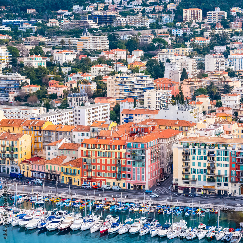 Nice in France, the harbor, old colorful buildings on the quays and boats in the marina 
