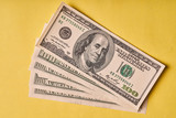 A few American dollars on a paper yellow background