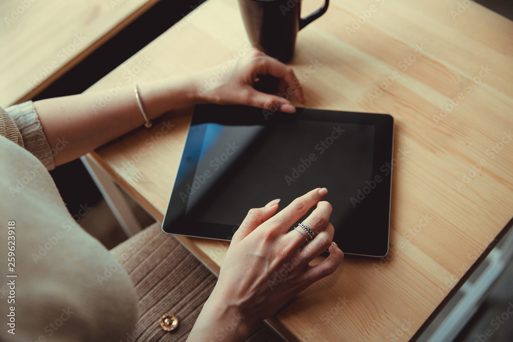 Woman using a touch screen tablet hands close up. Ipad Woman using a touch screen tablet hands close up. Ipad