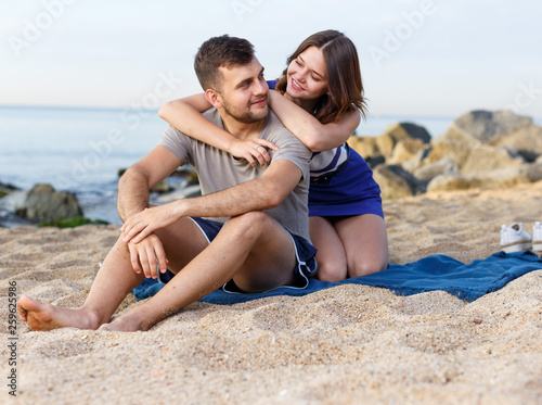 Happy loving couple sitting and hugging