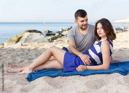 Young loving couple resting and hugging