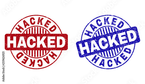 Grunge HACKED round stamp seals isolated on a white background. Round seals with grunge texture in red and blue colors. Vector rubber overlay of HACKED label inside circle form with stripes.