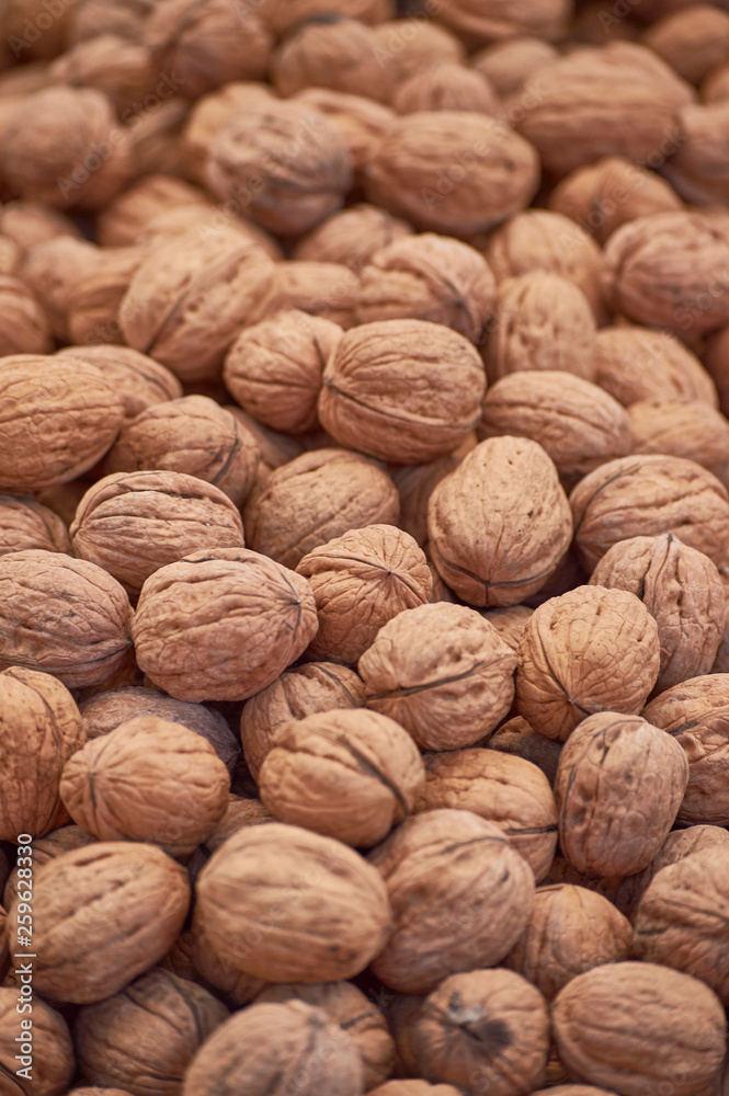closeup of walnuts on wooden background closeup of walnuts on wooden background